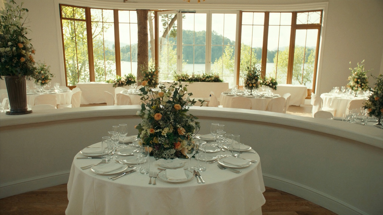 A gala event set up in a Citron Baltimore ballroom, with round tables, uplighting, and waterfront views